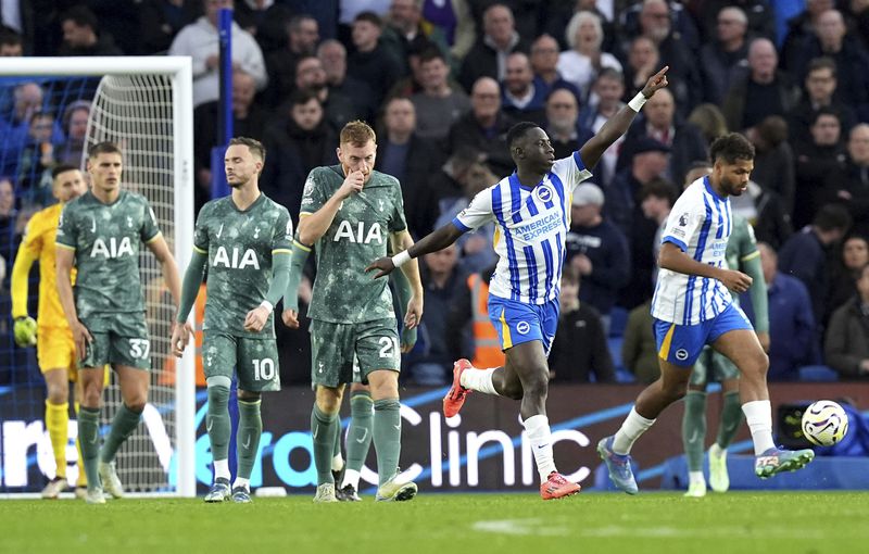 Brighton and Hove Albion's Yankuba Minteh, second right, celebrates scoring their side's first goal of the game during the Premier League match at the American Express Stadium, Brighton, England, Sunday Oct. 6, 2024. (Gareth Fuller/PA via AP)