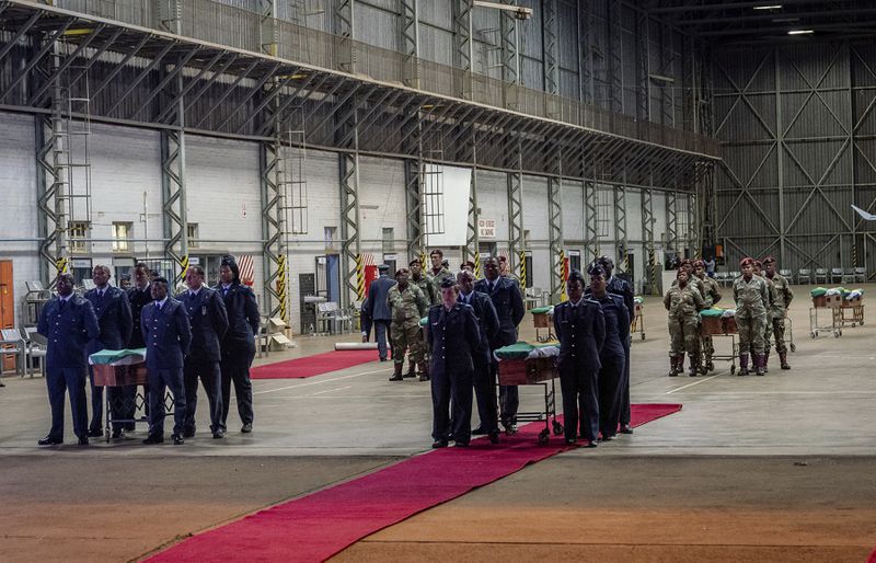 The remains of South Africans who died while exiled in Zimbabwe and Zambia during the struggle against white minority rule arrive at the Waterkloof Air Force Base in Pretoria, South Africa, Wednesday, Sept. 25, 2024. (AP Photo/Shiraaz Mohamed)