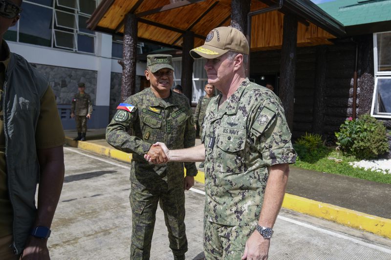 Philippines military chief Gen. Romeo Brawner, left, shakes hands with U.S. Indo-Pacific Command Commander Admiral Samuel Paparo after a press conference on the Mutual Defense Board-Security Engagement Board held at the Philippine Military Academy in Baguio, northern Philippines on Thursday, Aug. 29, 2024. (AP Photo/Aaron Favila)