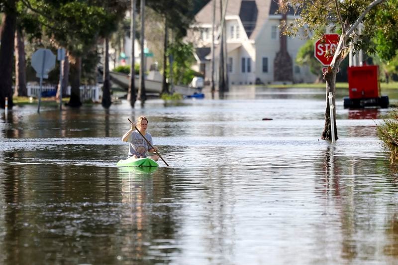 FILE - Halle Brooks kayaks down a street flooded by Hurricane Helene in the Shore Acres neighborhood Sept. 27, 2024, in St. Petersburg, Fla. (AP Photo/Mike Carlson, File)