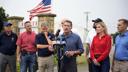 House Committee on Homeland Security Chairman Rep. Mark E. Green, R-Tenn., speaks to reporters after leading a bipartisan visit on Monday, July 22, 2024, to the site of the July 13 Trump campaign rally in Butler, Pa. Pictured from left are Rep. Carlos A. Jimenez, R-Fla., Rep. Josh Brecheen, R-Okla., Rep. Mike McCaul, R-Texas, Rep. Mike Kelly, R-Pa., rear, Rep. Eli Crane, R-Ariz., Rep. Laurel Lee, R-Fla., and Rep. Michael Guest, R-Miss. (AP Photo/Gene J. Puskar)