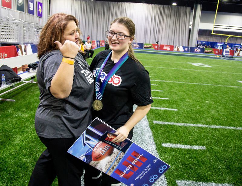 Morgan Mcneal is congratulated by her mother Chante after Morgan was presented tickets to the Super Bowl by the NFL during half time of the Special Olympics Unified Flag Football Game played before the opening of the 2019 Super Bowl Experience Driven By Hyundai at the World Congress Center on Jan. 29, 2019. (STEVE SCHAEFER / SPECIAL TO THE AJC)