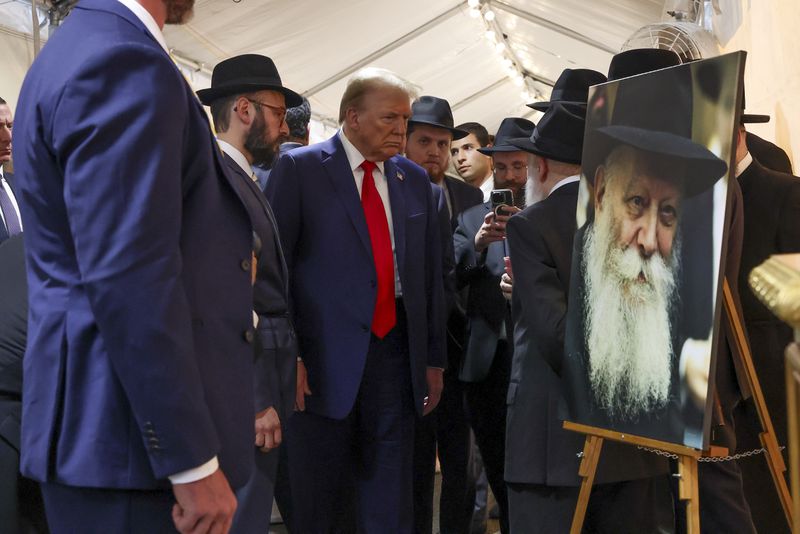 Republican presidential nominee former President Donald Trump arrives at Ohel Chabad-Lubavitch to visit the gravesite of Rabbi Menachem Mendel Schneerson, Monday, Oct. 7, 2024, in New York. (AP Photo/Yuki Iwamura)