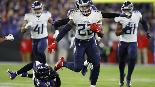 Tennessee Titans running back Derrick Henry (22) runs past Baltimore Ravens strong safety Chuck Clark (36) during the second half of an NFL divisional playoff football game, Saturday, Jan. 11, 2020, in Baltimore. (AP Photo/Julio Cortez)