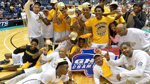 MARCH 7, 2015 MACON Wheeler Wildcats head coach Doug Lipscomb (bottom left) and other coaches and players celebrate their championship win. Coverage of Class AAAAAA boys state championship game between the Wheeler Wildcats and the Pebblebrook Falcons in the Georgia High School Basketball championships at the Macon Coliseum, Saturday, March 7, 2015. The Wheeler Wildcatswon over the Pebblebrook Falcons 59-58 on a pair of late free throws by Wheeler Wildcats Jaylen Brown (0). KENT D. JOHNSON/KDJOHNSON@AJC.COM