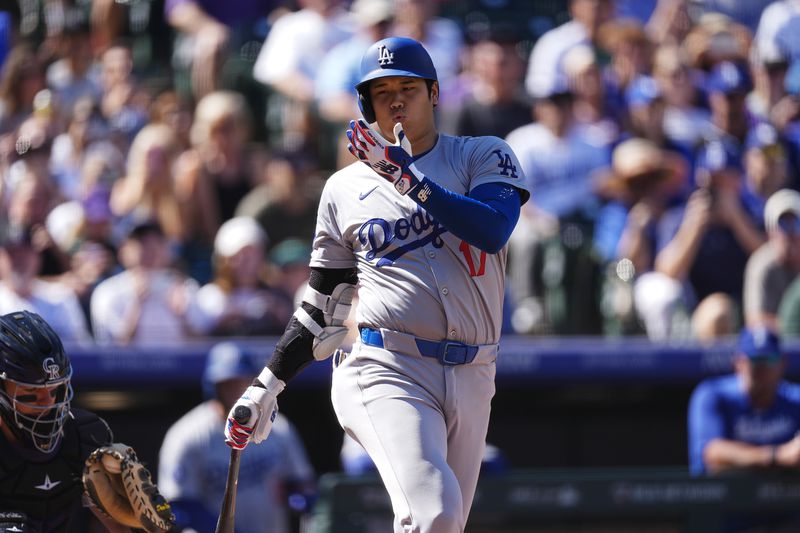 Los Angeles Dodgers' Shohei Ohtani swings at a pitch from Colorado Rockies starting pitcher Ryan Feltner in the first inning of a baseball game Sunday, Sept. 29, 2024, in Denver. (AP Photo/David Zalubowski)