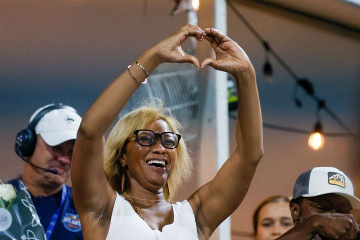 A woman who became engaged signals her gratitude with a heart to Sloane Stephens and Taylor Townsend during an exhibition match at the Atlanta Open on Sunday, July 21, 2024, in Atlanta.
(Miguel Martinez / AJC)