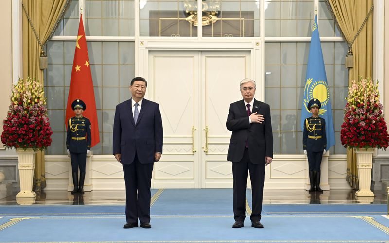 In this photo released by Kazakhstan's Presidential Press Office, President Kassym-Jomart Tokayev, right, and Chinese President Xi Jinping listen to the anthem as they attend an official welcome ceremony at the palace in Astana, Kazakhstan, on Wednesday, July 3, 2024. (Kazakhstan's Presidential Press Office via AP)