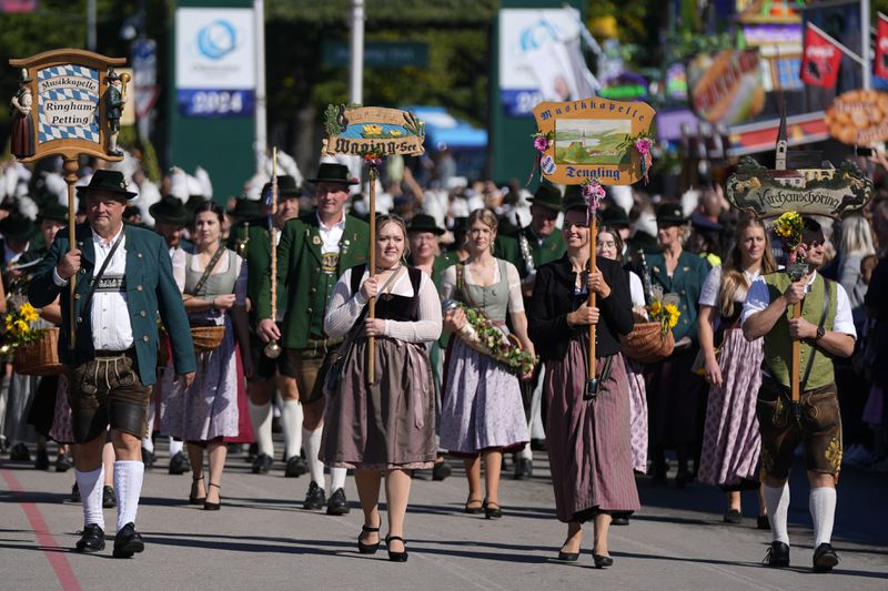 The traditional Oktoberfest music bands parade at the start of the 189th 'Oktoberfest' beer festival in Munich, Germany, Saturday, Sept. 21, 2024. (AP Photo/Matthias Schrader)