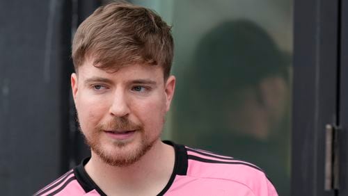 FILE - Jimmy Donaldson, the popular YouTube video maker who goes by MrBeast, wears a Lionel Messi jersey as he stands in a sideline box at the start of an MLS soccer match between Inter Miami and CF Montreal Sunday, March 10, 2024, in Fort Lauderdale, Fla. (AP Photo/Rebecca Blackwell, File)