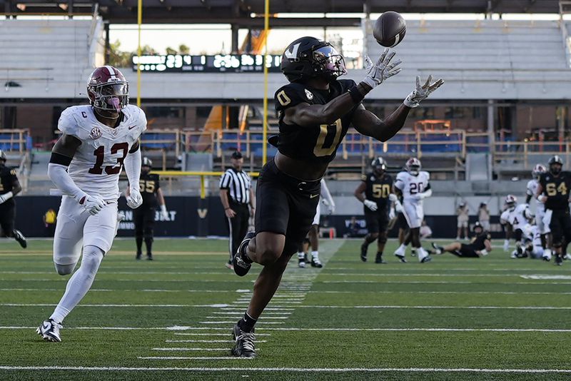 Vanderbilt wide receiver Junior Sherrill (0) makes a catch for a touchdown past Alabama defensive back Malachi Moore (13) during the second half of an NCAA college football game Saturday, Oct. 5, 2024, in Nashville, Tenn. (AP Photo/George Walker IV)