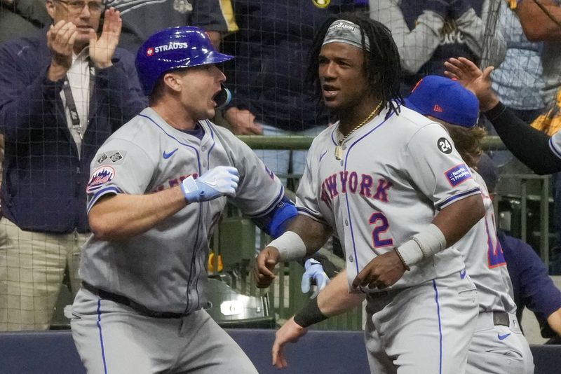 New York Mets' Pete Alonso celebrates his three-run home run with Luisangel Acuña during the ninth inning of Game 3 of a National League wild card baseball game against the Milwaukee Brewers Thursday, Oct. 3, 2024, in Milwaukee. (AP Photo/Morry Gash)