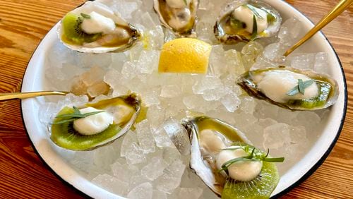 At Fishmonger, you can get oysters served with extra virgin olive oil, kiwi, tarragon and citrus foam. (Angela Hansberger for The Atlanta Journal-Constitution)