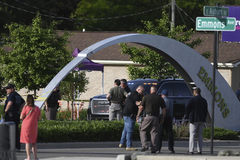 Officials with the Oakland County Sheriff's Department, Rochester Hills Fire Department and other jurisdictions secure the scene of a shooting at the Brooklands Plaza Splash Pad, Saturday, June 15, 2024, in Rochester Hills, Mich. (Daniel Mears/Detroit News via AP)