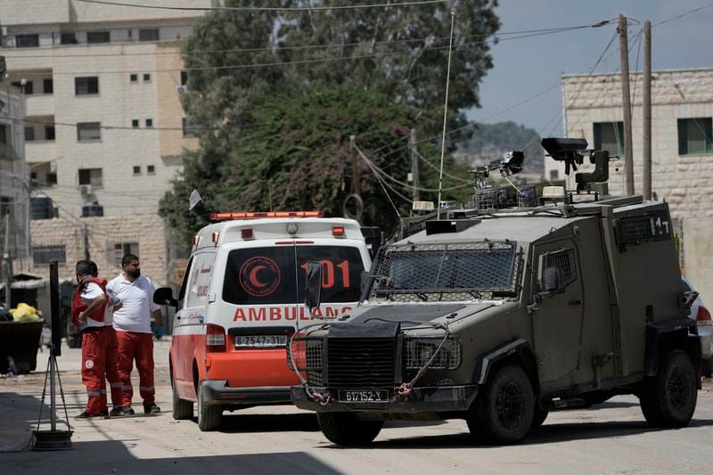 Members of the Israeli forces inside an armoured vehicle check an ambulance during a military operation in the West Bank city of Jenin, Wednesday, Aug. 28, 2024. (AP Photo/Majdi Mohammed)