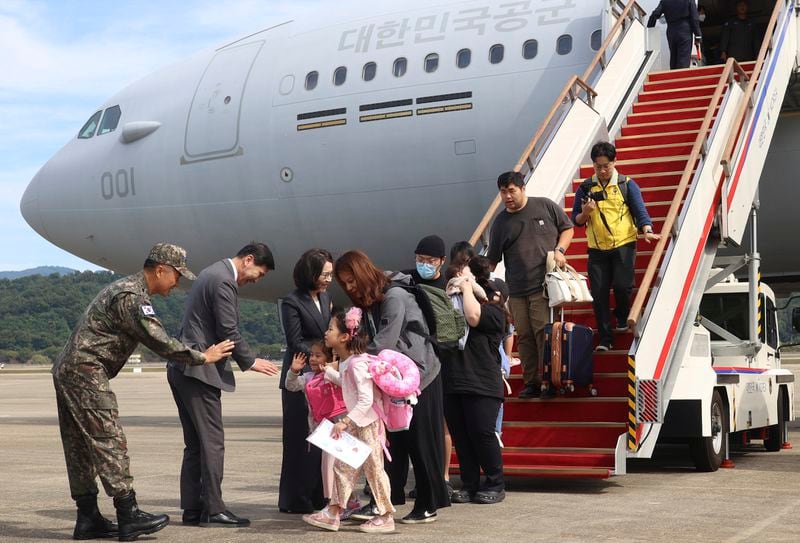 South Korean nationals and their family members arrive after being evacuated from Lebanon with a South Korea's military aircraft at the Seoul airport in Seongnam, South Korea, Saturday, Oct. 5, 2024. (Korea Pool/Yonhap via AP)