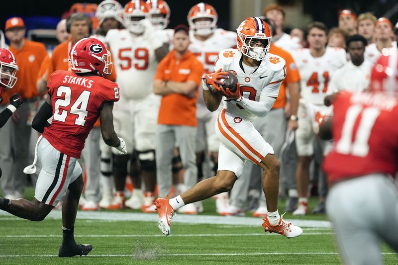 Clemson wide receiver Antonio Williams (0) makes a catch as Georgia defensive back Malaki Starks (24) defends during the first half of an NCAA college football game Aug. 31, 2024, in Atlanta. (AP Photo/John Bazemore)