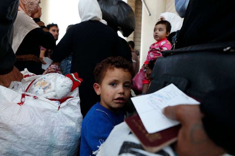 A Syrian boy fleeing the war in Lebanon with his family, arrives at the Syrian-Lebanese border crossing in Jdeidet Yabous, Syria, Wednesday, Sept. 25, 2024. (AP Photo/Omar Sanadiki)