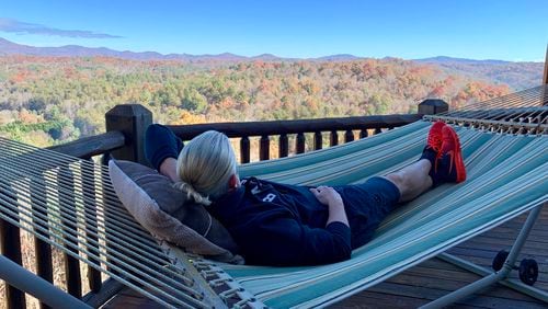 What If Cabin Airbnb host T.J. enjoys the scenic views from the porch hammock.