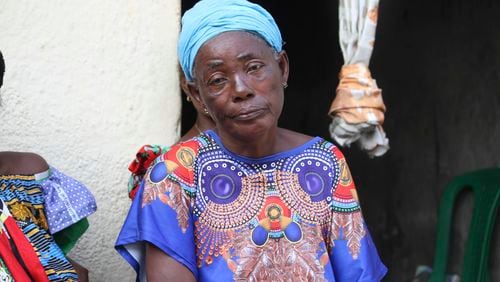 Madeleine Mbalaka, whose son was killed during the recently attempted jailbreak sits outside her house in Kinshasa, Congo, Tuesday, Sept. 3, 2024. Families of those that died in what Congo's authorities described as an attempted jailbreak in the country's biggest prison demand answers from the government, as criticism mounts over what activists describe as inhumane conditions in Congo's overcrowded penitentiary facilities. (AP Photo/Benz Bokote)