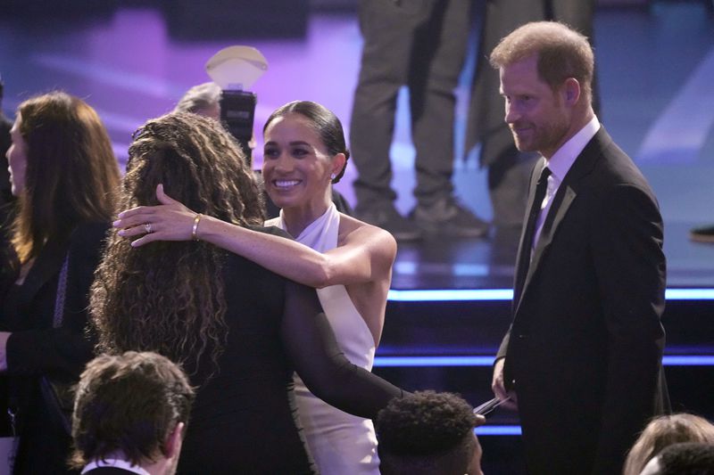 Meghan Markle, center and Prince Harry, right, arrive at the ESPY awards on Thursday, July 11, 2024, at the Dolby Theatre in Los Angeles. (AP Photo/Mark J. Terrill)