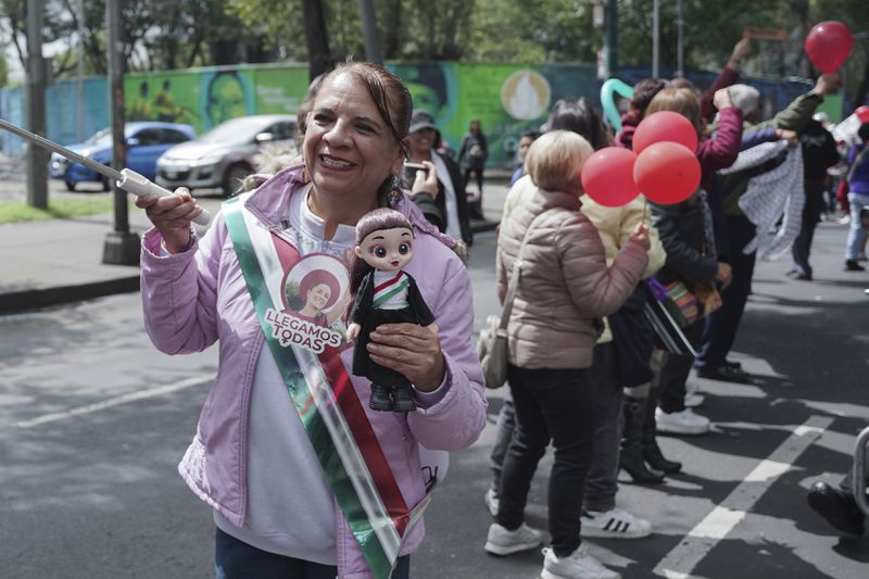 Supporters of Claudia Sheinbaum cheer as her vehicle passes on the way to her swearing-in as Mexico's new president in Mexico City, Tuesday, Oct. 1, 2024. (AP Photo/Aurea Del Rosario)