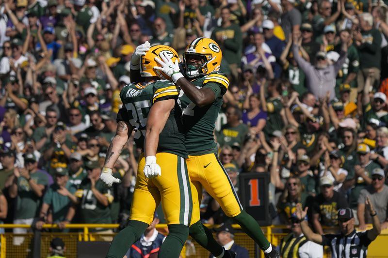 Green Bay Packers tight end Tucker Kraft, left, and wide receiver Romeo Doubs, right, celebrate a touchdown during the second half of an NFL football game against the Minnesota Vikings, Sunday, Sept. 29, 2024, in Green Bay, Wis. (AP Photo/Morry Gash)