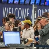 Passengers seek assistance at Delta ticket counters at Hartsfield-Jackson International Airport on Wednesday, July 24, 2024. (John Spink / John.Spink@ajc.com)