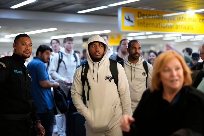 The Green Bay Packers' Josh Jacobs, center, and teammates arrive at Sao Paulo International airport ahead of a game against the Philadelphia Eagles, in Guarulhos, greater Sao Paulo, Brazil, Wednesday, Sept. 4, 2024. (AP Photo/Andre Penner)