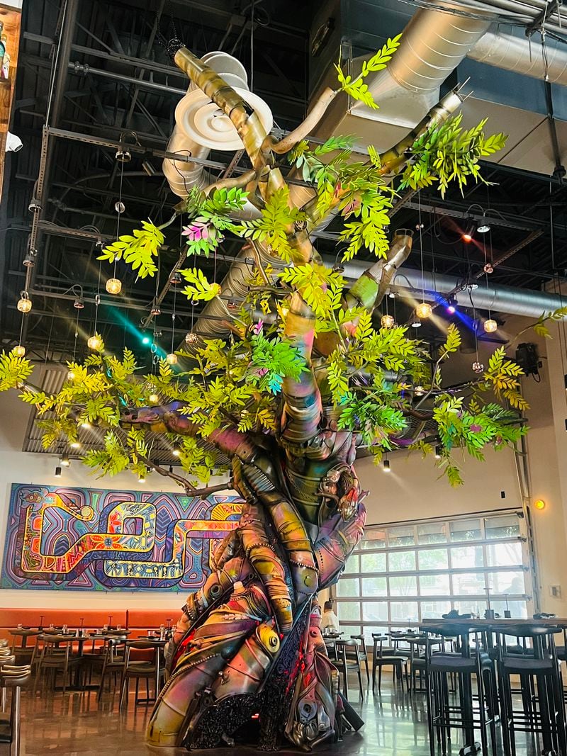 The Tree of Life sculpture by local artist Jonathan Imafidor dominates the dining room at Alta Toro in Midtown. Courtesy of Alta Toro 