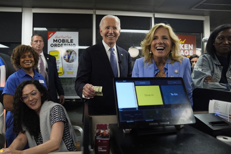 President Joe Biden (center) and first lady Jill Biden (second from right)  greet customers at a Waffle House in Marietta on Friday.
