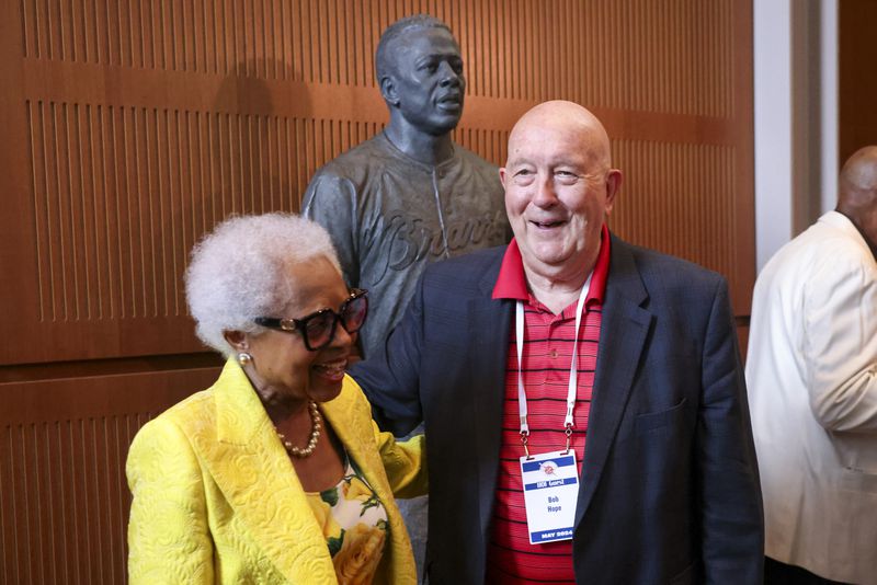 Billye Aaron, Hank Aaron’s widow, greets former Braves public relations staffer Bob Hope after the unveiling of the Hank Aaron statue by the grand staircase at the National Baseball Hall of Fame, Thursday, May 23, 2024, in Cooperstown, NY. (Jason Getz / AJC)
