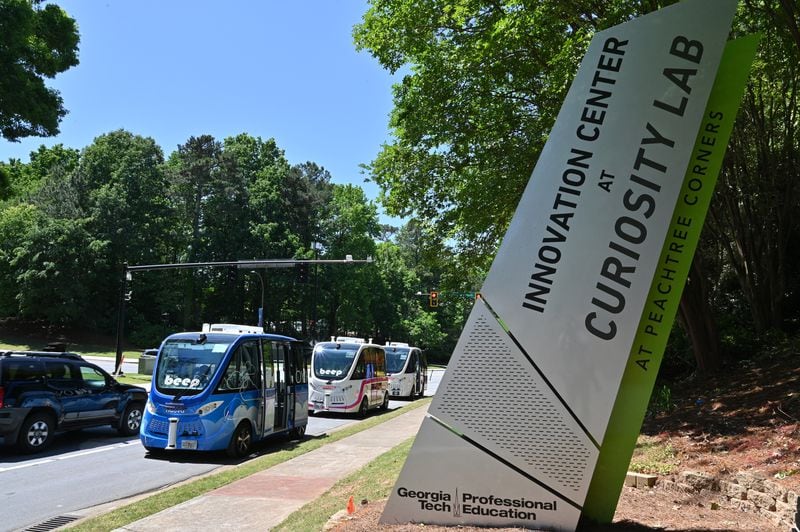 Electric autonomous shuttles are ready for demonstration on May 12, 2022, at Curiosity Lab shuttle stop in Peachtree Corners. (Hyosub Shin/Hyosub.Shin@ajc.com)