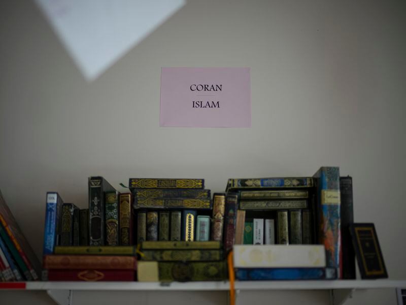 Islamic books are displayed in the library at Ibn Khaldoun, a private Muslim school, in Marseille, southern France, Tuesday, April 16, 2024. (AP Photo/Daniel Cole)