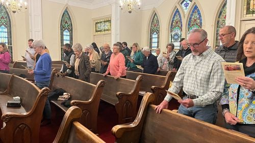 Worshippers from several denominations sing together during a sunrise service in Plains on Easter.