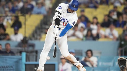 Los Angeles Dodgers designated hitter Shohei Ohtani grounds out during the eighth inning of a baseball game against the Seattle Mariners in Los Angeles, Wednesday, Aug. 21, 2024. (AP Photo/Ashley Landis)