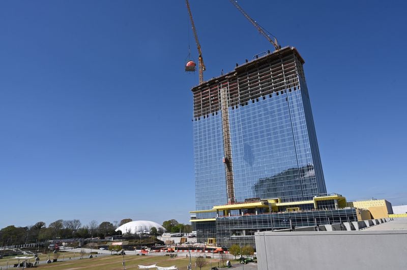 A gigantic peach is lifted up to the top during topping out ceremony of Signia by Hilton Atlanta at Georgia World Congress Center, Thursday, March 23, 2023, in Atlanta. Plans are in motion for GWCCA’s new headquarter hotel Signia by Hilton Atlanta. Featuring close to 1,000 rooms, this premier full-service hotel will sit on the northwest corner of the campus, adjacent to Building C of Georgia World Congress Center. (Hyosub Shin / Hyosub.Shin@ajc.com)