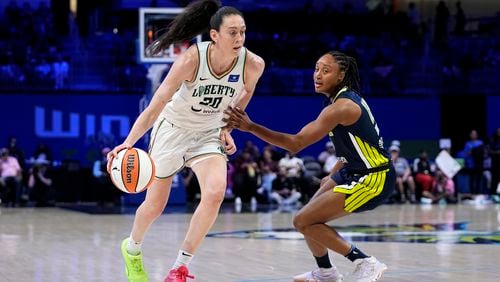 New York Liberty guard Sabrina Ionescu (20) works against Dallas Wings guard Jaelyn Brown, right, in the second half of a WNBA basketball game, Thursday, Sept. 12, 2024, in Arlington, Texas. (AP Photo/Tony Gutierrez)