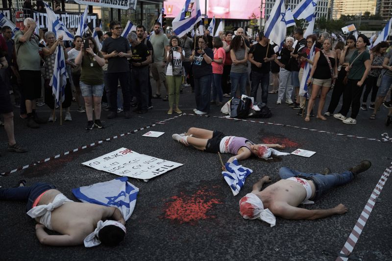 Demonstrators are painted red, symbolizing blood during a protest against Israeli Prime Minister Benjamin Netanyahu's government and demanding elections, in Tel Aviv, Israel, Saturday, June 22, 2024. (AP Photo/Leo Correa)