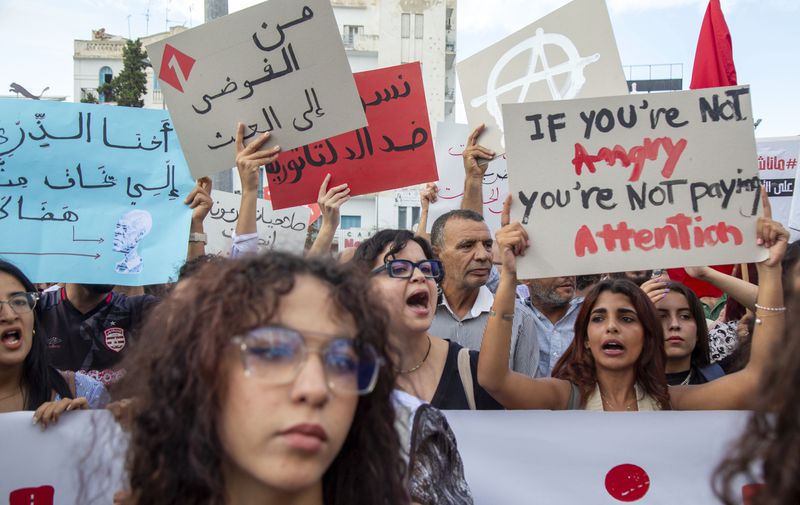 Tunisian take part in a protest against President Kais Saied ahead of the upcoming presidential elections, Friday, Sept. 13, 2024, on Avenue Habib Bourguiba in the capital Tunis. Banner in Arabic reads "Women against dictatorship." (AP Photo/Anis Mili)