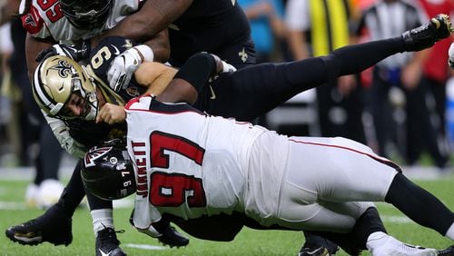 Drew Brees  of the New Orleans Saints is sacked by Grady Jarrett  of the Atlanta Falcons and Adrian Clayborn during the second half of a game at the Mercedes Benz Superdome on November 10, 2019 in New Orleans, Louisiana. (Photo by Jonathan Bachman/Getty Images)