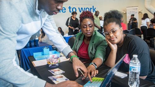 Karen Mitchell (center), CEO of Justin Global Solutions LLC, interacts with job seekers at a job fair hosted by Goodwill Career Center in Atlanta on Tuesday, July 9. (Ziyu Julian Zhu/AJC)