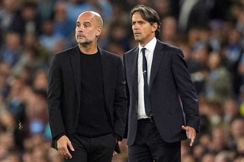 Manchester City manager Pep Guardiola, left, and Inter Milan manager Simone Inzaghi, right, during the Champions League opening phase soccer match between Manchester City and Inter Milan in Manchester, England, Wednesday, Sept. 18, 2024. (Martin Rickett/PA via AP)