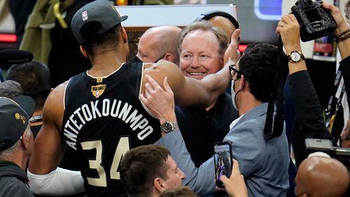 Milwaukee Bucks forward Giannis Antetokounmpo (34) hugs coach Mike Budenholzer after defeating the Phoenix Suns. Budenholzer is a former Hawks head coach. (AP Photo/Paul Sancya)