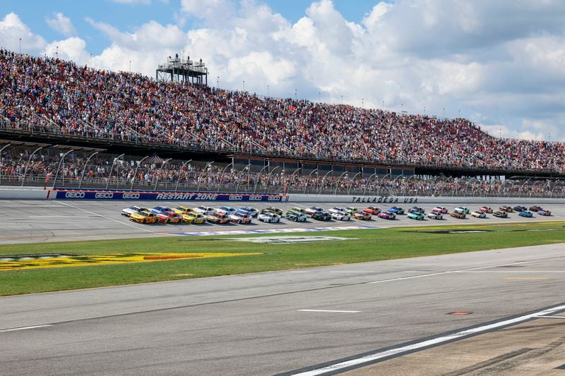 Driver Michael McDowell (34) leads the pack to the start of a NASCAR Cup Series auto race at Talladega Superspeedway, Sunday, Oct. 6, 2024, in Talladega, Ala. (AP Photo/ Butch Dill)