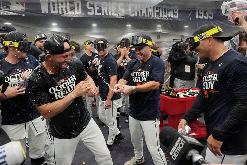 The Detroit Tigers celebrate their AL wild card berth after the ninth inning of a baseball game against the Chicago White Sox, Friday, Sept. 27, 2024, in Detroit. (AP Photo/Carlos Osorio)