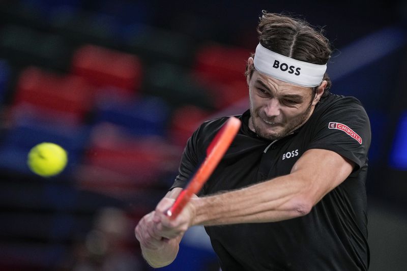 Taylor Fritz of the United States returns a shot to Terence Atmane of France during the men's singles second round match in the Shanghai Masters tennis tournament at Qizhong Forest Sports City Tennis Center in Shanghai, China, Monday, Oct. 7, 2024. (AP Photo/Andy Wong)