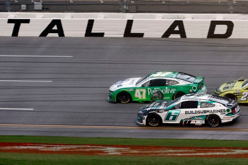 Driver Ricky Stenhouse Jr. (47) leads the way to the finish line during a NASCAR Cup Series auto race at Talladega Superspeedway, Sunday, Oct. 6, 2024, in Talladega, Ala. (AP Photo/ Butch Dill)