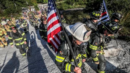 Wearing full firefighting gear, about 200 metro Atlanta area firefighters honored the firefighters, paramedics and law enforcement officers who lost their lives on Sept. 11, 2001, by ascending Stone Mountain in 2001. (John Spink / AJC FILE PHOTO)