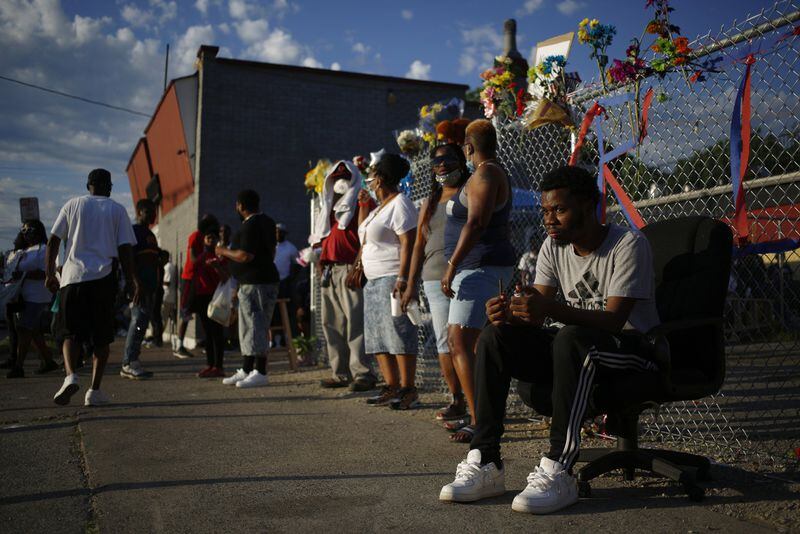 People gather outside the restaurant owned by David McAtee in Louisville, Ky., on June 2, 2020. McAtee was shot and killed by law enforcement officers enforcing a curfew imposed during protests sparked by the death of George Floyd, an African American man, in Minneapolis police custody. 